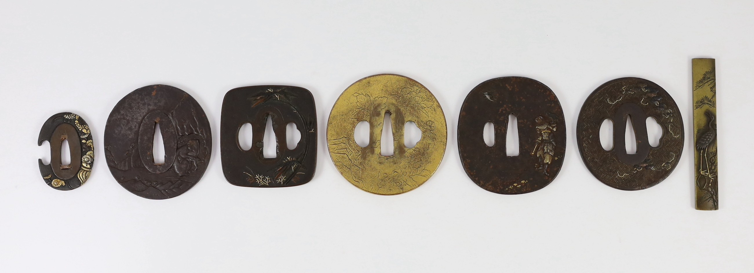 A group of Japanese bronze, iron and mixed metal tsuba and a kozuka knife handle, 19th century